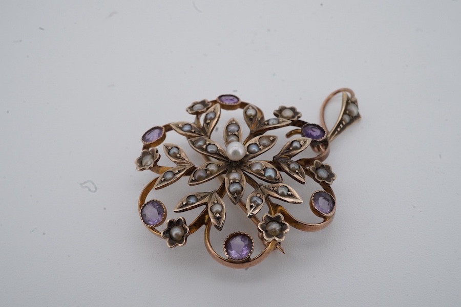 An Edwardian seed pearl and amethyst pendant, early 20th century, of floral design, set with seed pearls and circular-cut amethysts, mounted in gold, length 4cm including bail, brooch fitting, stamped 9ct and H&GB, Condi